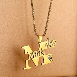 Gold-plated name necklace by Visoire — personalized with “Mida in the initial M”